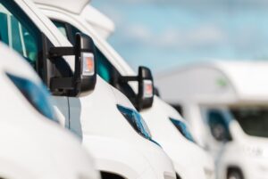 Closeup of sideview mirrors on row of commercial fleet