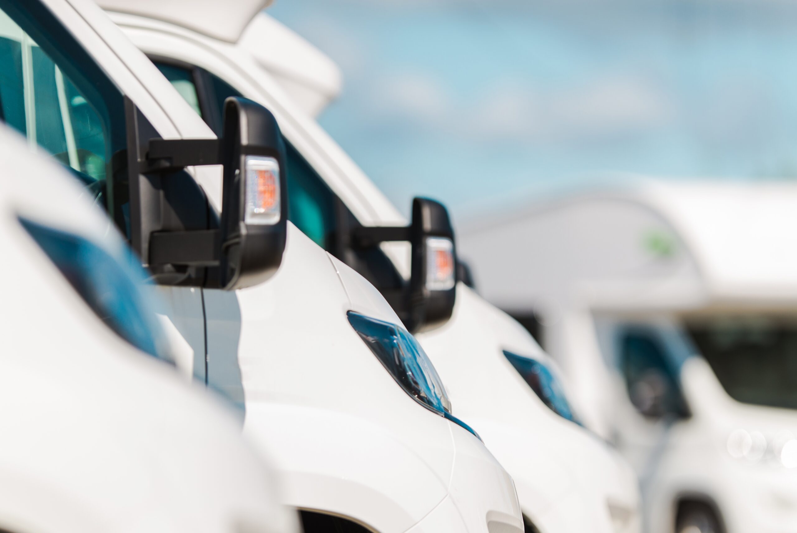 Closeup of sideview mirrors on row of commercial fleet