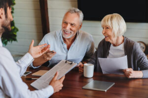Smiling couple talking with insurance agent