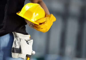 Closeup of yellow construction helmet being held