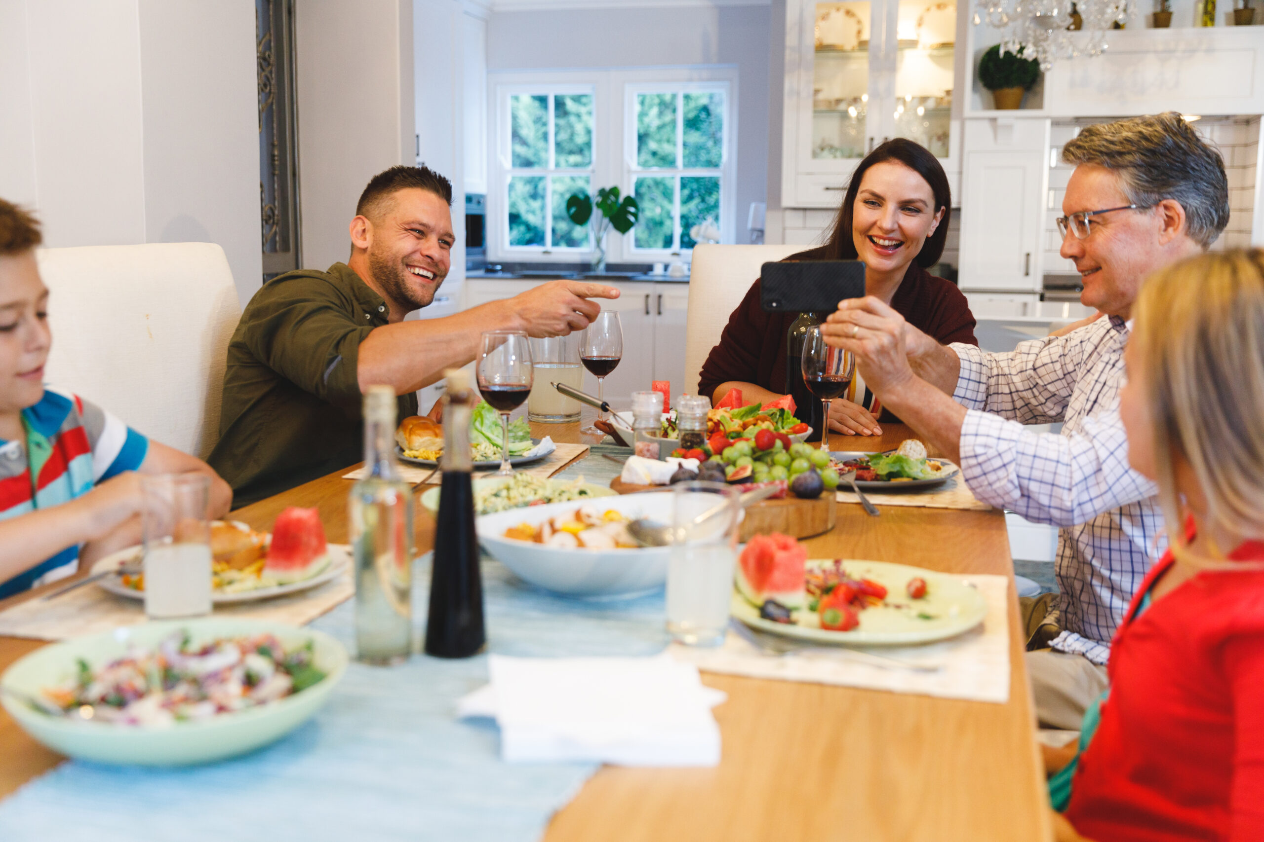 Family laughing at the dinner table