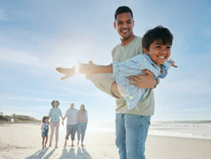Father and son playing on the beach