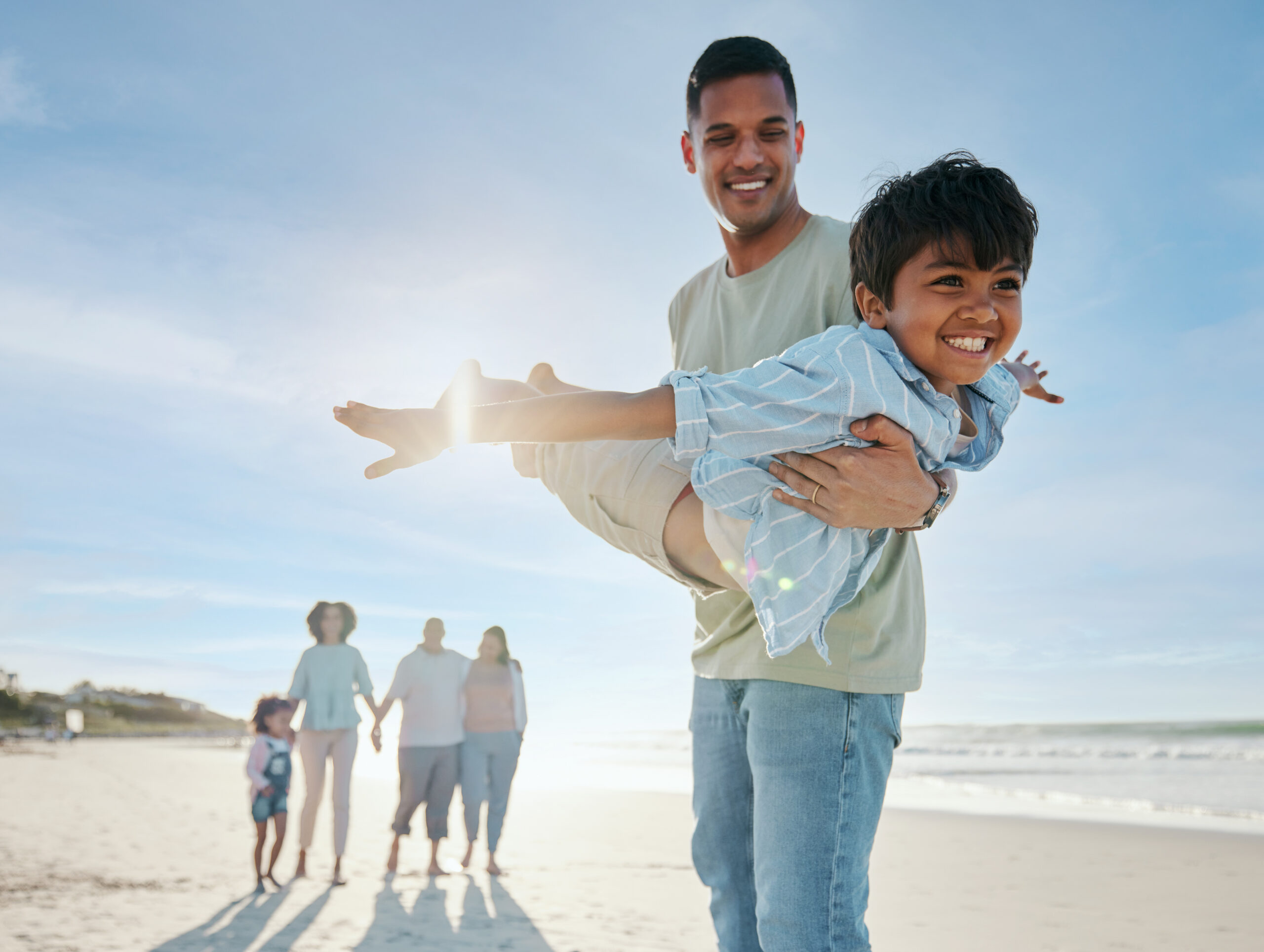 Father and son playing on the beach
