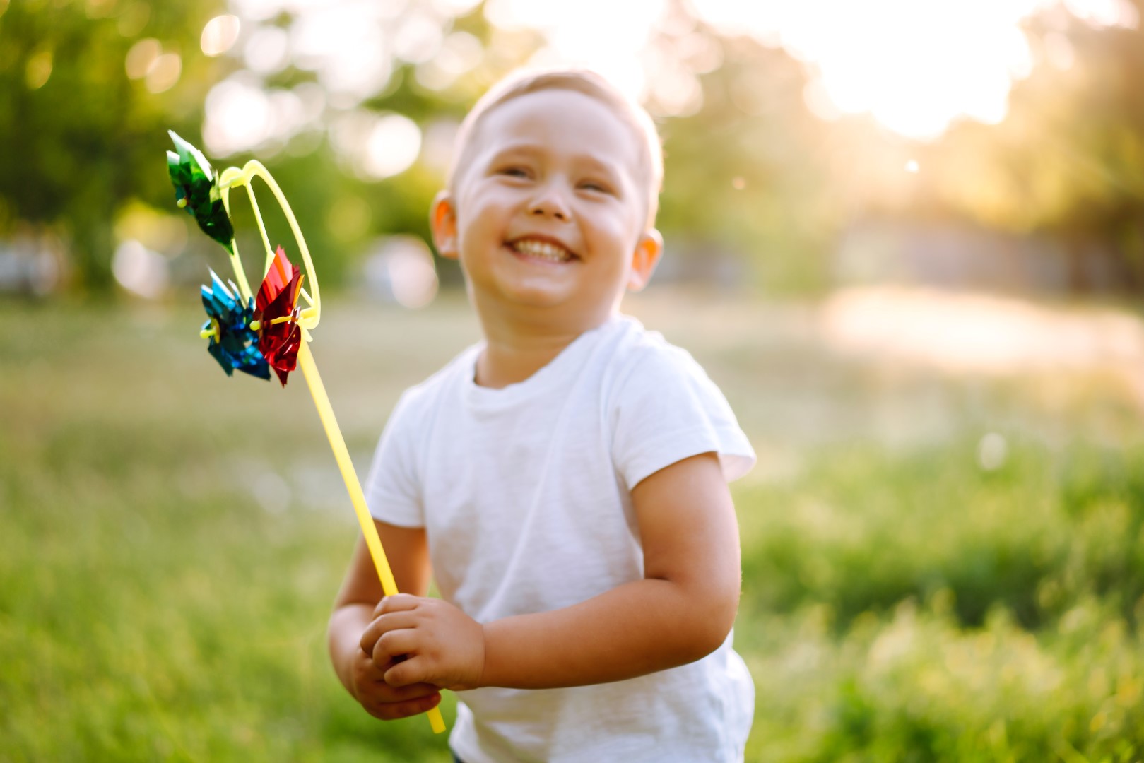 small boy holding pinwheel