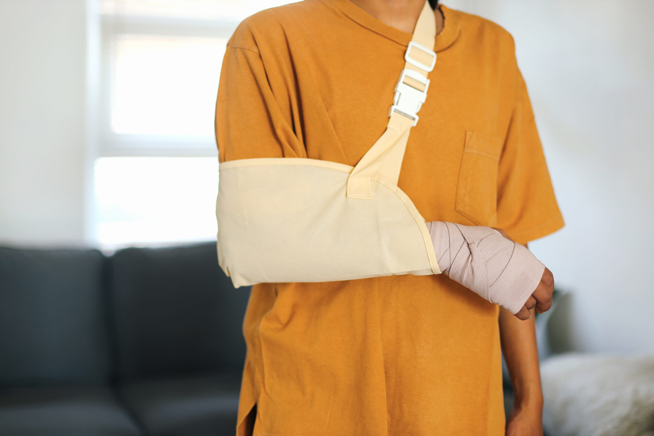 person wearing arm bandage and sling