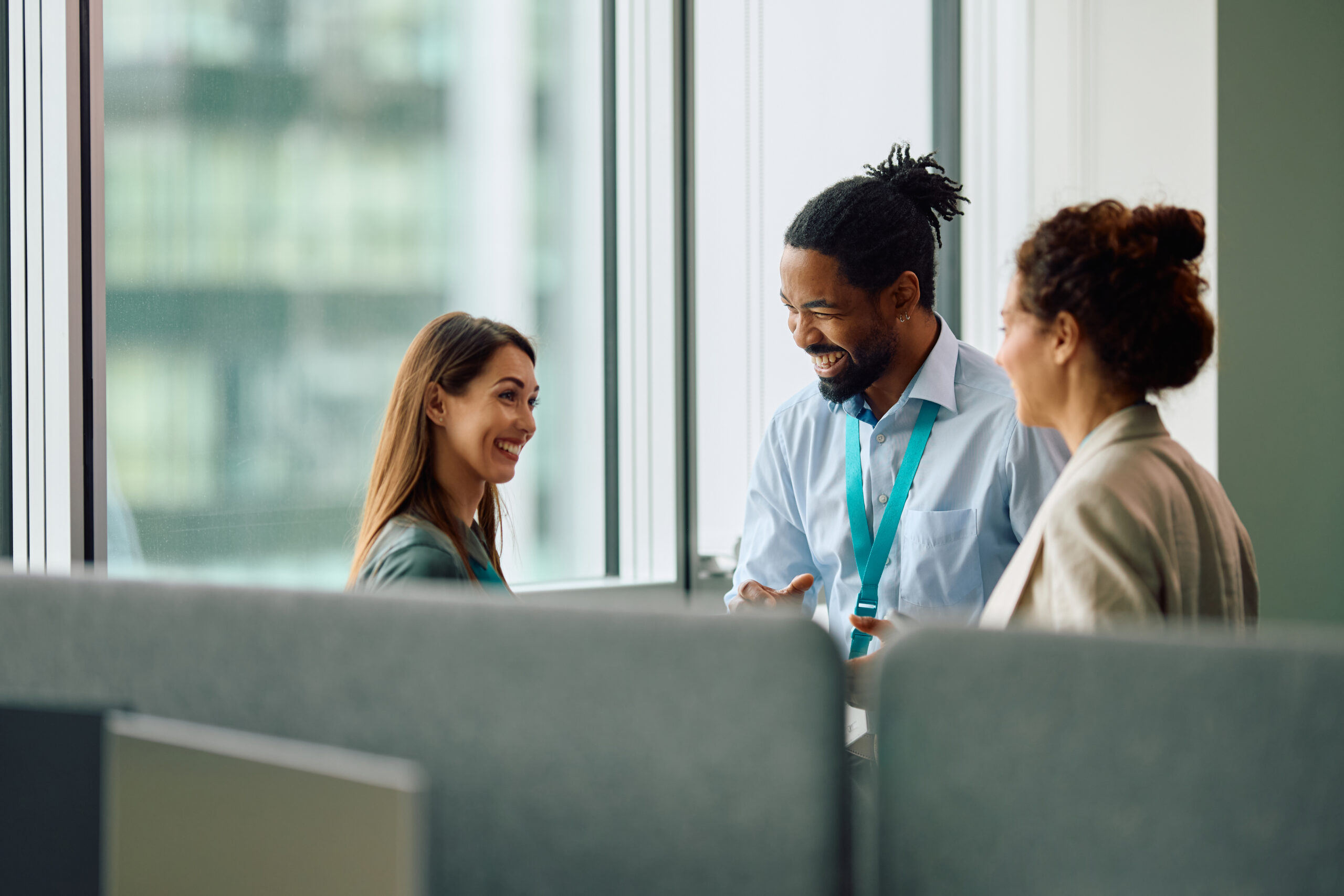 three coworkers chatting in office