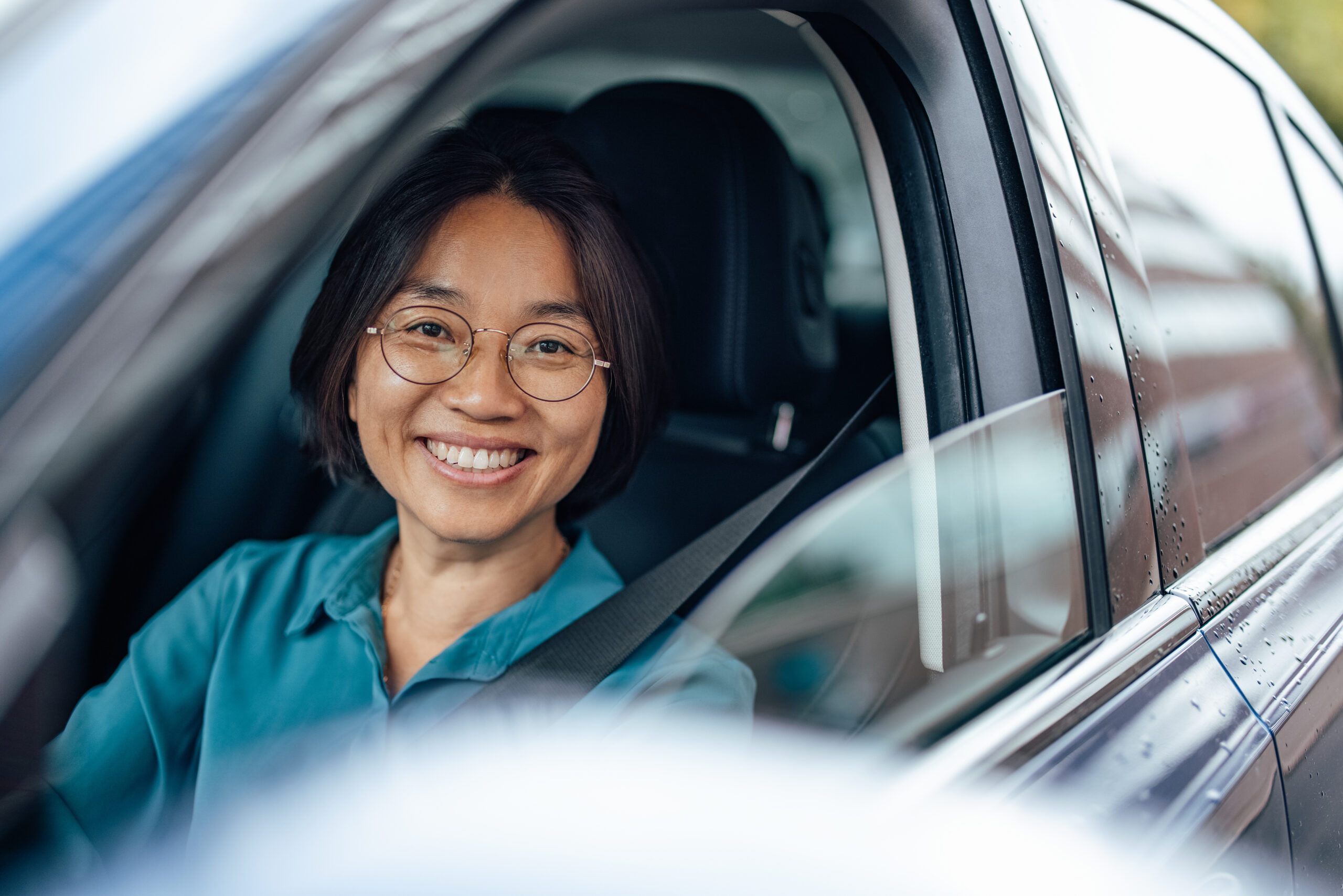 smiling woman in driver's seat