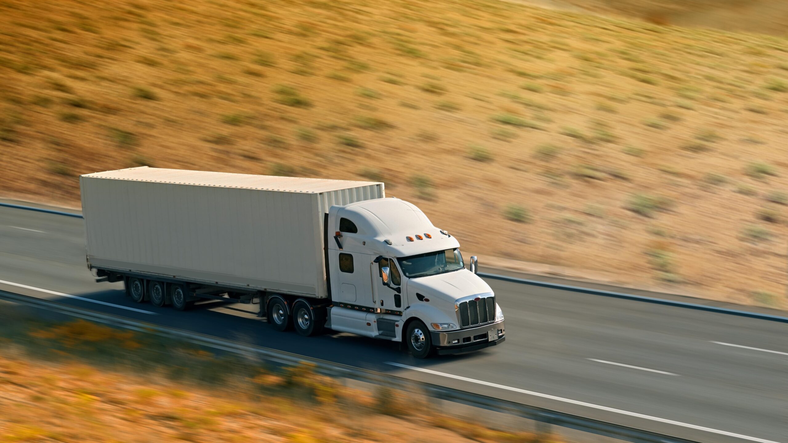 Semi truck moving fast on road