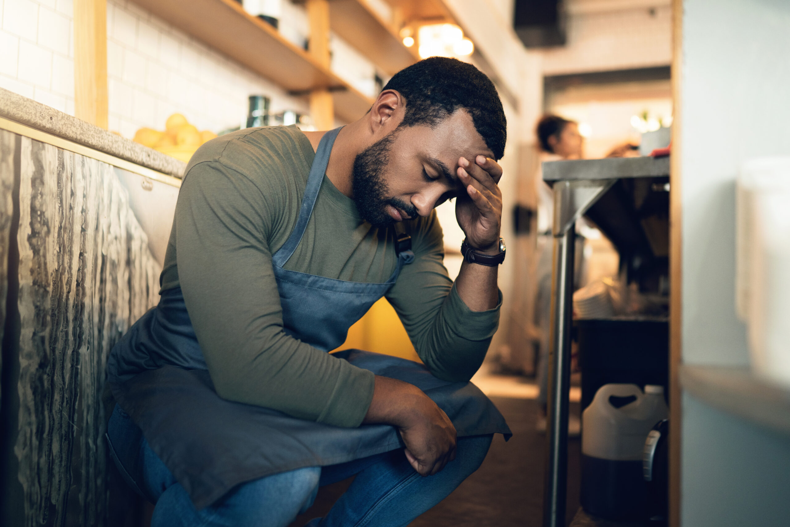 worried businessman with hand on head