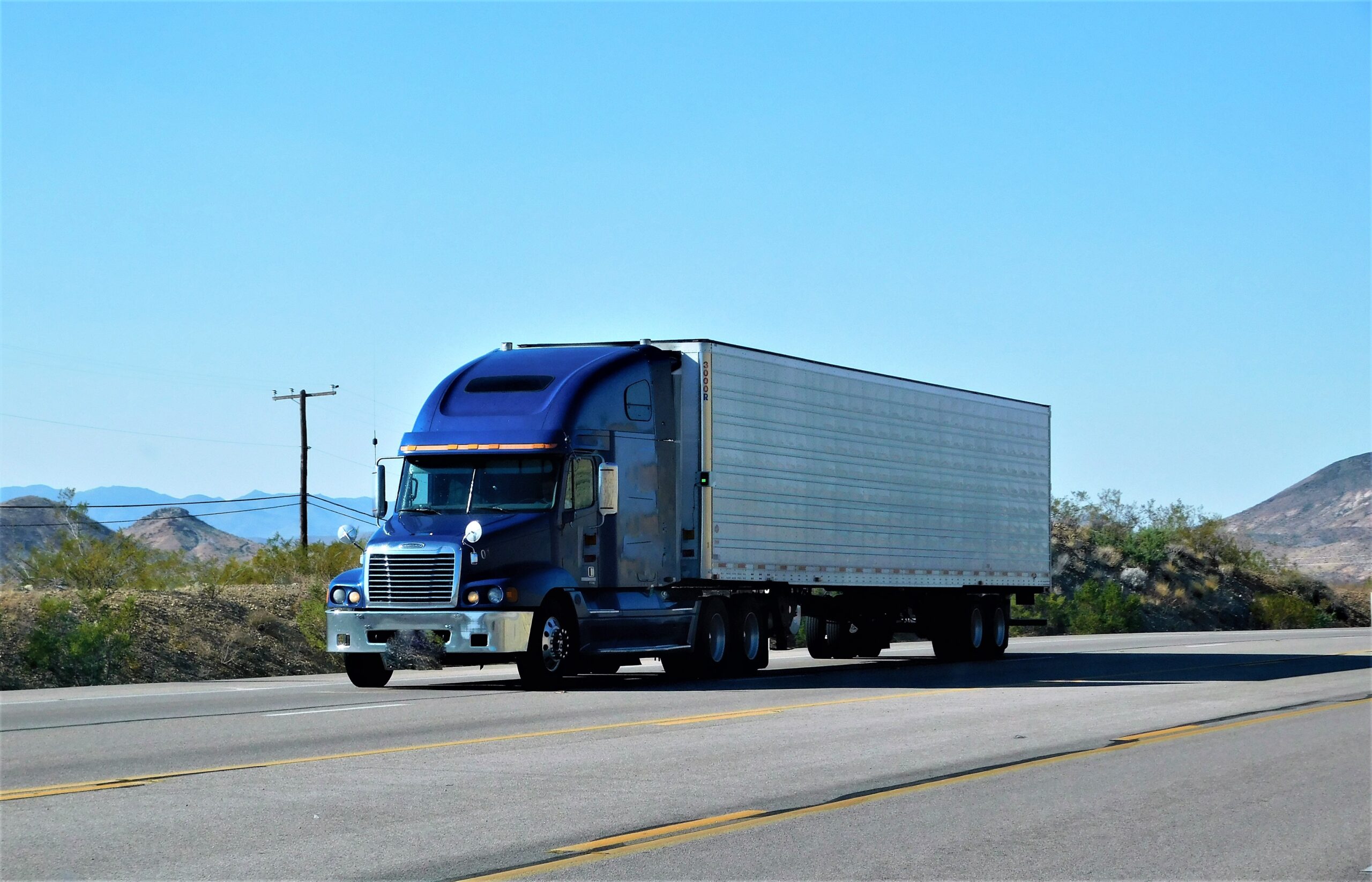 blue semi truck on highway