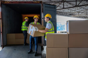 workers unloading boxes from truck